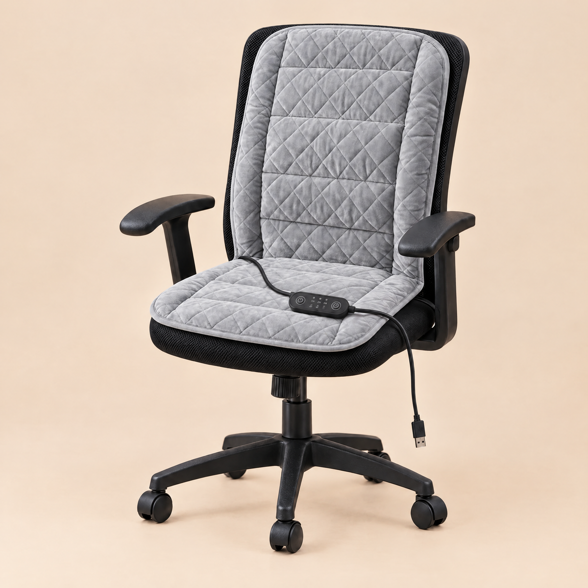 Snugseat heated chair pad in light grey on a black office chair, with USB controller on the seat